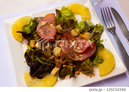 Tasty exotic salad from bacon, mushrooms and pineapple with cheese Tasty exotic salad from bacon, mushrooms and pineapple with cheese 120210398