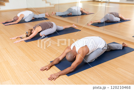 Group yoga class - pose (Balasana) 120210468