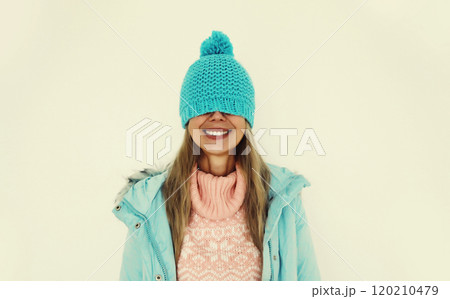 Portrait of happy funny smiling young woman in blue winter hat having fun on white background Portrait of happy funny smiling young woman in blue winter hat having fun on white background 120210479