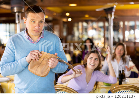 Man leaving restaurant after stealing woman's handbag 120211137