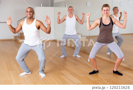 Man dancing at group lesson in studio 120211628