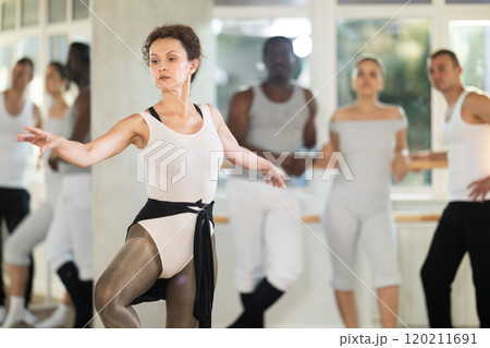Adult woman teacher showing ballet movements Adult woman teacher showing ballet movements 120211691