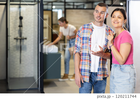 Man and woman looking around in bathroom department of store 120211744