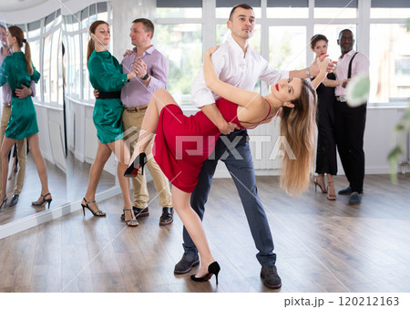 Woman dances incendiary tango with man partner during choreography lesson 120212163