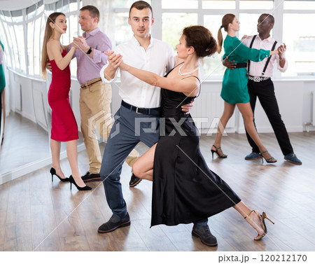 Woman and young man practicing waltz in dancing studio 120212170