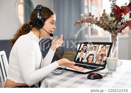 Woman working from home having video conference Woman working from home having video conference 120212258