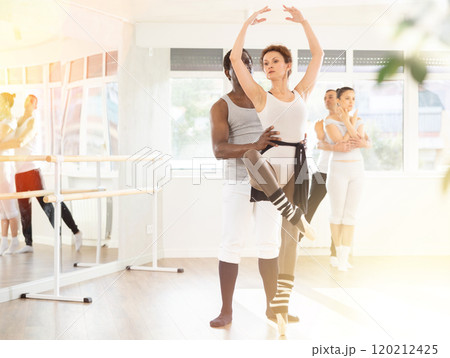Adult man and adult woman rehearsing pair ballet 120212425