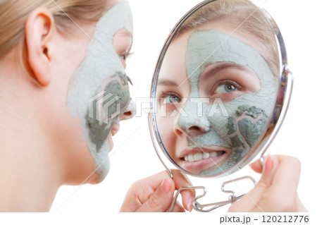 Woman having mud green mask on her face Woman having mud green mask on her face 120212776