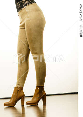 Woman wearing suede leggings and high heels 120212792