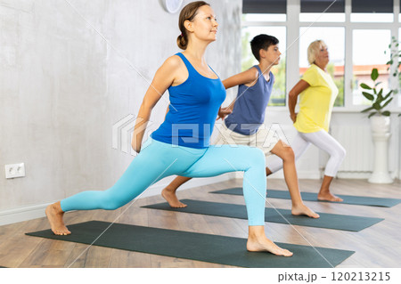 Group of three people doing yoga 120213215