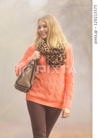 Happy fashion woman with handbag in autumn park 120213575