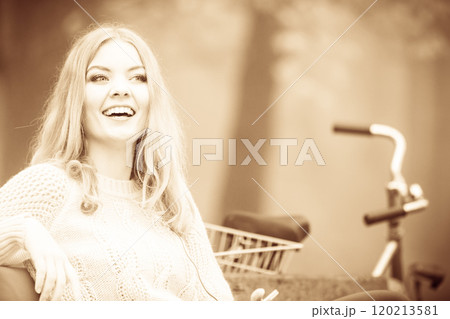 Attractive woman sitting on the bench. Attractive woman sitting on the bench. 120213581