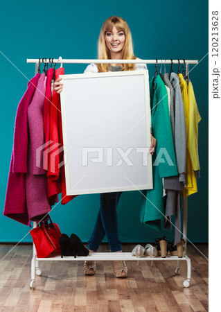 Woman in mall wardrobe with blank banner copyspace 120213628