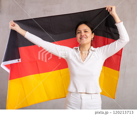 Young woman posing in studio with Germany flag Young woman posing in studio with Germany flag 120213713
