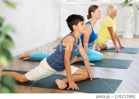 Group of people perform pigeon asana Group of people perform pigeon asana 120213962