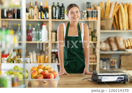 Young woman seller at counter in grocery store Young woman seller at counter in grocery store 120214370