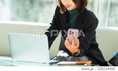 パソコンとスマホを使う女性・ビジネスウーマン 120214491