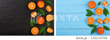 orange or tangerine with leaves on black stone and blue wooden background. Flat lay, top view. Fruit composition 120214709