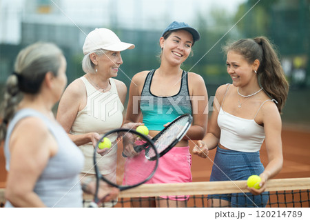 Group of women talking on tennis court Group of women talking on tennis court 120214789