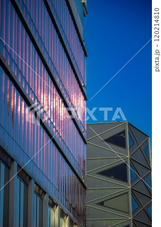 Contemporary residential building exterior in the daylight. Modern apartment buildings on a sunny day with a blue sky. 120214810