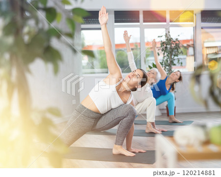 Young woman doing yoga in fitness studio 120214881