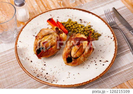 Two baked quails with carrots and canned green peas Two baked quails with carrots and canned green peas 120215109