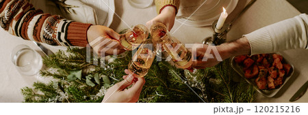 Website banner with unrecognizable people sitting at festive table and clinking glasses of champagne while celebrating Christmas together Website banner with unrecognizable people sitting at festive table and clinking glasses of champagne while celebrating Christmas together 120215216