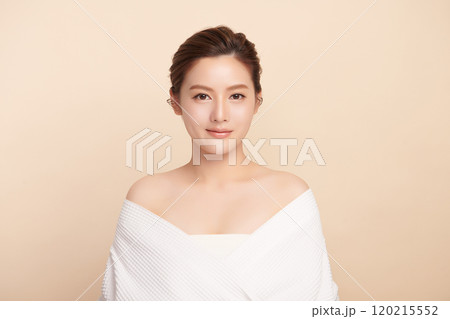 Beautiful young asian woman with clean fresh skin on beige background, Face care, Facial treatment, Cosmetology, beauty and spa, Asian women portrait. 120215552