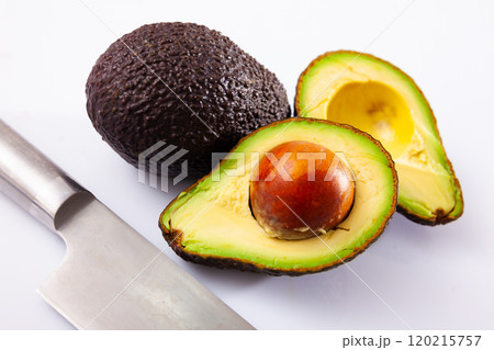 Avocadoes and kitchen knife on white background 120215757