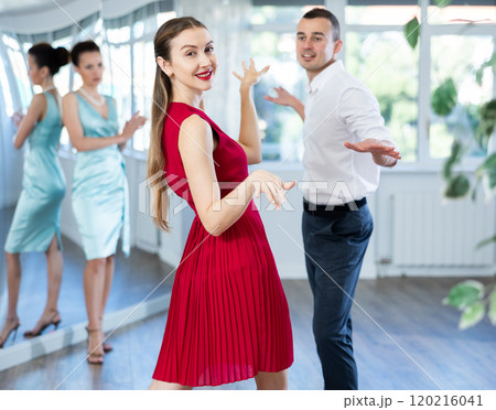 Couple in stage costumes learns boogie woogie dancing during individual lesson Couple in stage costumes learns boogie woogie dancing during individual lesson 120216041
