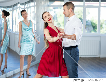 Elegant couple rehearsing sensual wedding dance in studio 120216353