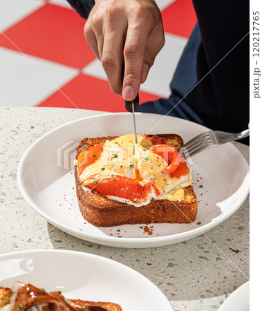Brioche breakfast toast with egg and salmon 120217765