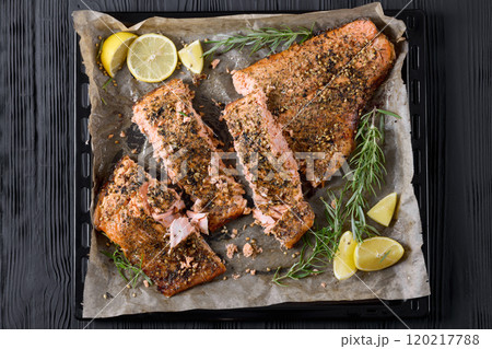 baked salmon fillet on baking tray, top view 120217788