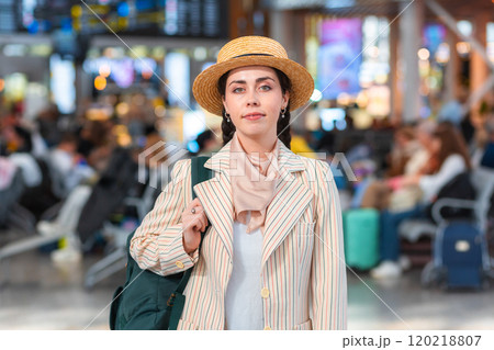 Portrait of pretty Caucasian young woman in straw hat wear backpack. Checking and boarding flight. The concept of vacation and flight trip Portrait of pretty Caucasian young woman in straw hat wear backpack. Checking and boarding flight. The concept of vacation and flight trip 120218807