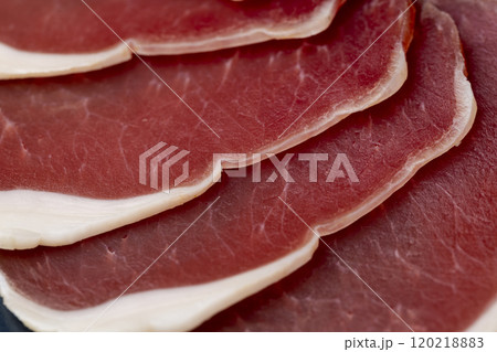 sliced ham with bacon on a board 120218883