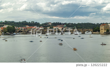 View of the city Prague in Czech Republic with colorful paddle boats timelapse on the Vltava river on a beautiful day 120221222