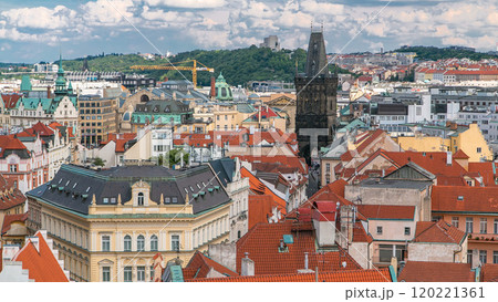 Aerial view of the traditional red roofs of the city of Prague, Czech Republic with the Powder tower and Vitkov Hill in the distance timelapse. 120221361