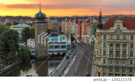 Sitkovska water-tower timelapse and traffic on road in old city center of Prague at sunset time. 120221378
