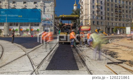 Workers operating asphalt paver machines during road construction and repairing works timelapse Workers operating asphalt paver machines during road construction and repairing works timelapse 120221861