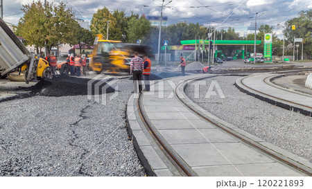 Asphalt roller and excavator on the road repair site during asphalting timelapse. Road construction equipment. Asphalt roller and excavator on the road repair site during asphalting timelapse. Road construction equipment. 120221893