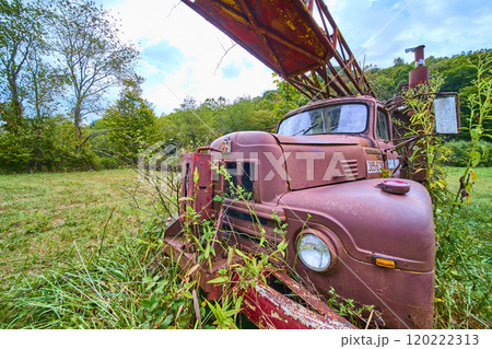 Rusted Vintage Truck Overgrown with Vegetation in Ohio Countryside Eye Level View 120222313