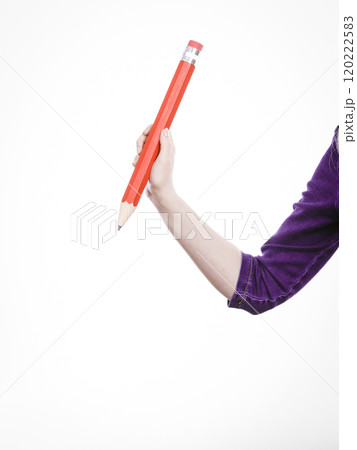 Female hand holds big red pencil 120222583