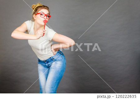 Happy woman holding fake lips on stick Happy woman holding fake lips on stick 120222635