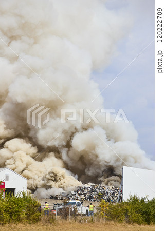 Scrap Yard Fire and Smoke Plume with Workers in Motion, Eye Level Perspective 120222709