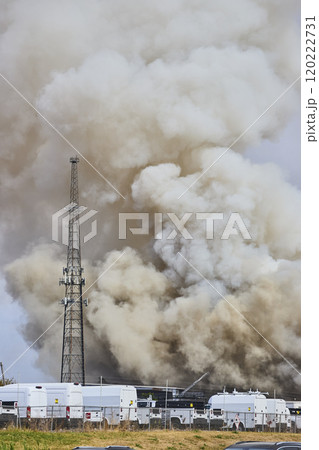Massive Smoke Plume Over Scrap Metal Fire with Response Vehicles Eye Level View Massive Smoke Plume Over Scrap Metal Fire with Response Vehicles Eye Level View 120222731