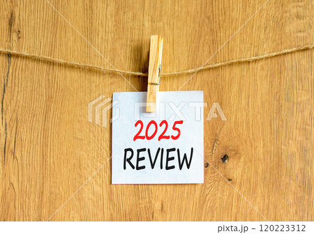 Planning 2025 review new year symbol. Concept words 2025 Review on beautiful white paper on wooden clothespin. Beautiful wooden background. Business 2025 review new year concept. Copy space. Planning 2025 review new year symbol. Concept words 2025 Review on beautiful white paper on wooden clothespin. Beautiful wooden background. Business 2025 review new year concept. Copy space. 120223312