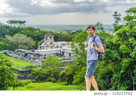 Man tourist exploring the ancient pyramids of Palenque, Mexico, surrounded by dense jungle. Cultural heritage and adventure travel concept Man tourist exploring the ancient pyramids of Palenque, Mexico, surrounded by dense jungle. Cultural heritage and adventure travel concept 120223782