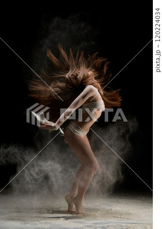 Slim blonde in bandage in dust cloud profile shot 120224034