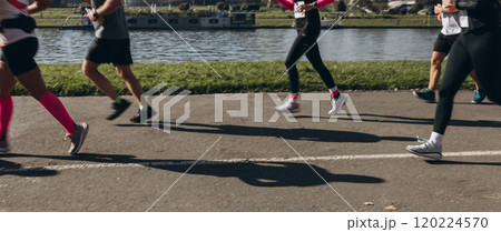 Motion blurred marathon runners in a city. Group of marathon runners compete in the race outdoors 120224570