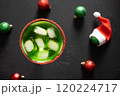 Xmas Grinch Punch in glass decorated sugar rim on black table make of cool lime sherbet. Tasty drink for Christmas holiday. Rim your festive beverages in red sugar. Close up. 120224717